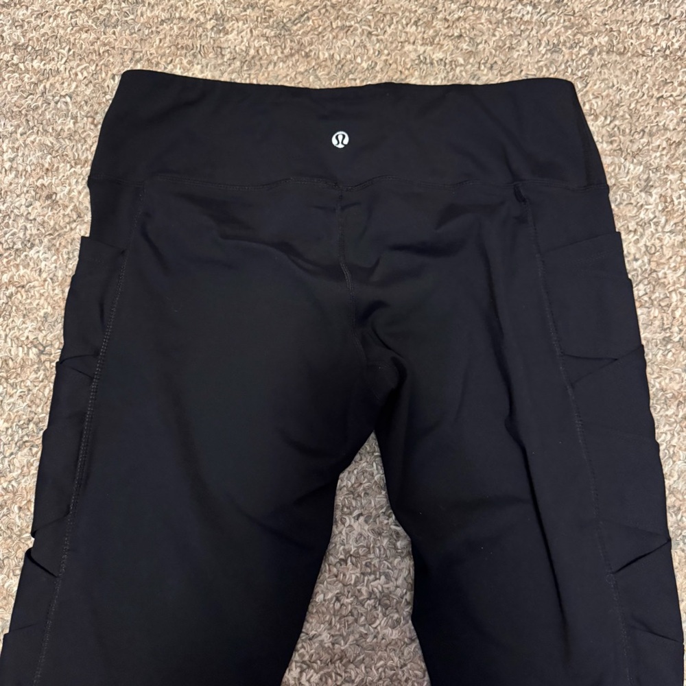 Lululemon black high-rise leggings with lattice mesh side details
